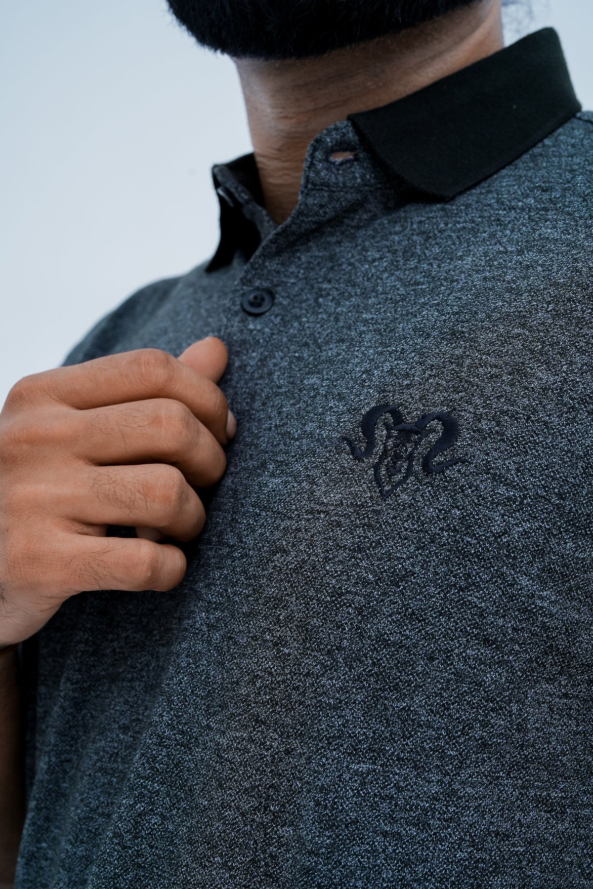 Onyx Contrast Polo - chest emblem close up